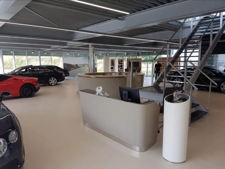 Opgeleverde showroom met balie, trap en zwevend plafond